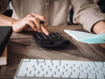 close-up-asian-business-woman-using-a-calculator-to-calculate-the-numbers-business-finances-and-accounting-concept